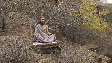 Yogi meditating at mountains in autumn
