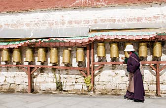 Tibetan turns pray wheel