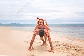 Young friendly family father and dauther are happy in summer Christmas on beach