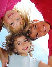 Below view of happy three children embracing