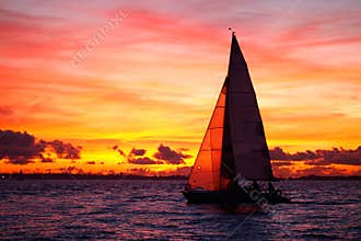 Yacht sailing at sunset