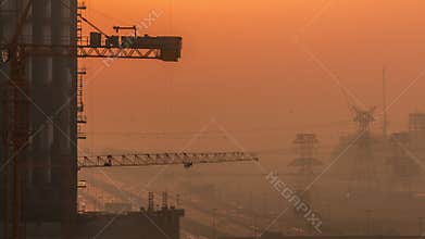 Construction of new modern skyscrapers aerial timelapse in luxury Dubai city at sunset, United Arab Emirates