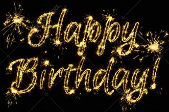 Celebration concept. Text Happy Birthday written sparkling sparklers isolated on black background. Overlay template for greeting
