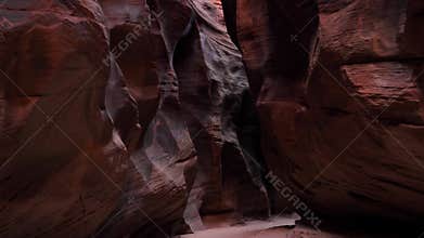 Camera movement in deep slot canyon with curved and smooth sandstone walls