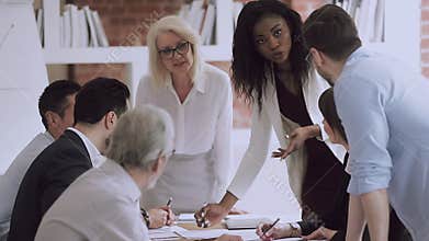 Black businesswoman team leader manager talk to employees at meeting