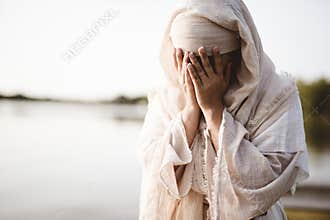 Closeup shot of a female wearing a biblical robe crying  - concept confessing sins