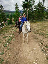 Old Lady Riding a Horse With Grandkids in Colorado
