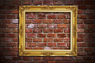 Gold frame on old brick wall