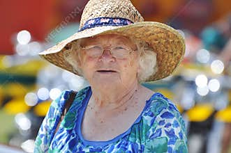 Senior woman celebrating Australia Day in traditional flags hat outdoors