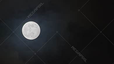 Full moon against cloudy night sky