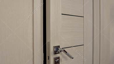 Burglar behind the door with a gun. The masked thug slowly opened the door and went into the room.