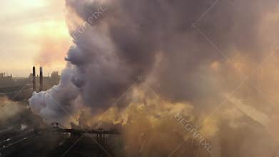 Aerial. GLOBAL WARMING. View of high chimney pipes with grey smoke. Pipes Pollute Industry Atmosphere With Smoke Ecology