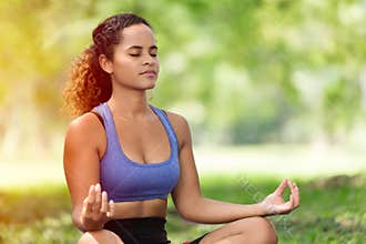 Women doing yoga concentration for mental health meditation outdoor park girl black Caucasian race