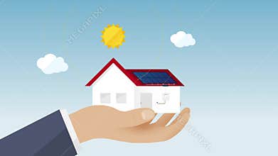 Hand with family house construction and solar energy system - ecological concept