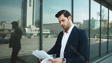 Closeup businessman studding documents. Business man throwing papers at street