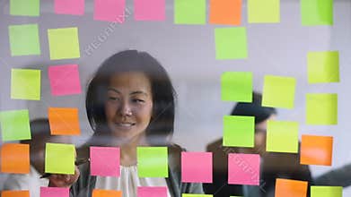 Happy older korean female worker managing project processes.