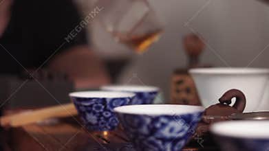Pours hot tea, a Chinese ceremony selective focus.