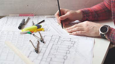 Young architect working in the office.