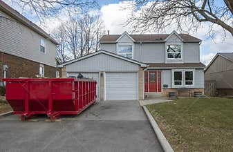 Red Dumpster Bin on the Driveway of a Suburban House #1