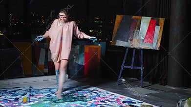 Foot painting amused woman enjoying dancing