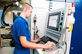 Worker operating CNC machine center
