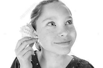 Girl listening to seashell