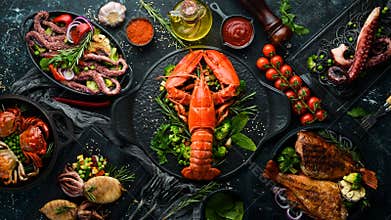 Set of seafood dishes. Fish, squid, octopus on a black stone background. Top view.