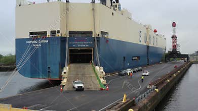 Aerial View of Cars Rolling Off a Car Carrying Ship