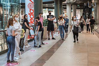 People in the shopping center with face masks due to coronavirus pandemic