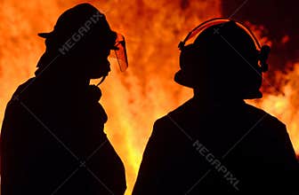 Firefighters on duty at wildfire wild forest fire out of control in night