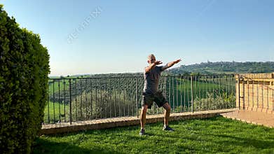 Man doing squat exercises in the garden