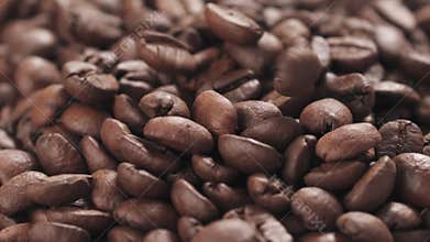 Slow motion closeup coffee beans falling into bowl