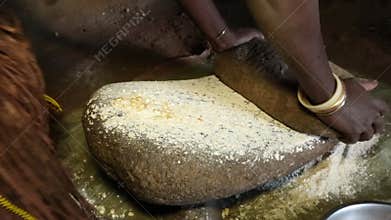 African woman preparing common ugali made from maize flour.