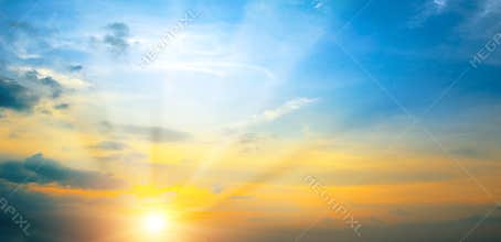 Panoramic photo bright spring sunset with blue sky, red sun