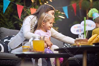 Mother and daughter on kids birthday party together
