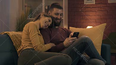 Happy loving couple social networking on the phone