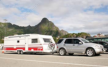 Luxury car caring caravan with bikes on