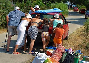 People pushing a car