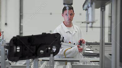 Quality engineer programs a machine for 3D measurement of plastic casting in the automotive industry