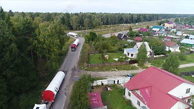 The huge parts of the wind generator are being transported by a convoy of trucks