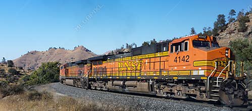 BNSF railroad locomotives haul a freight train toward famous Tehachapi Loop, California