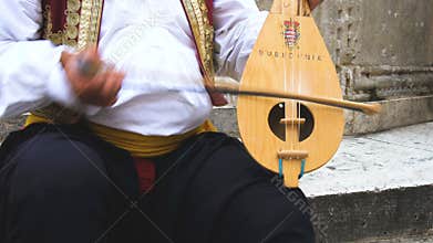 Man Plays Croatian Musical Instrument in Dubrovnik