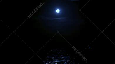 The light of the full moon is reflected in the sea water, the full moon in the sea