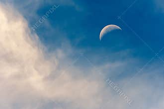 Daytime Crescent Moon with Clouds in Sky