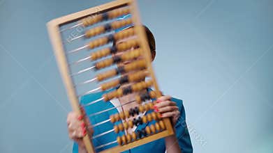 Attractive joyful stewardess is holding an abacus. Low-cost airline.