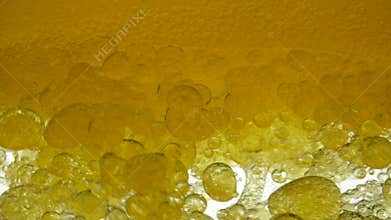 Sunflower yellow oil is mixed with water, not dissolve. Bubbles air bulbs float in liquids creating fancy patterns