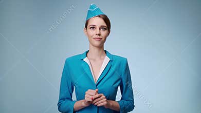 The charming stewardess is dressed in a blue uniform.