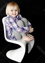 Happy baby girl on chair