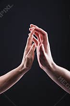 A close-up of two hands male and female gently touch each other. The concept tremulous rejection between the sexes