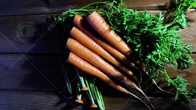 A row of carrots on a rotating wooden table